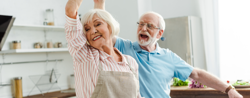 Life Assure Senior Woman Sitting In Chair And Laughing With Caregiver Nurse Hero